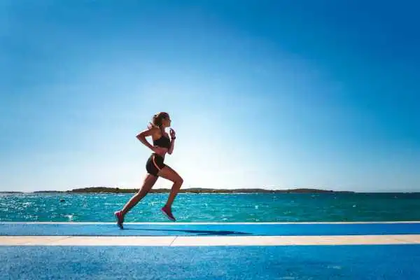 Woman running showing strong leg muscle Central Milton Keynes